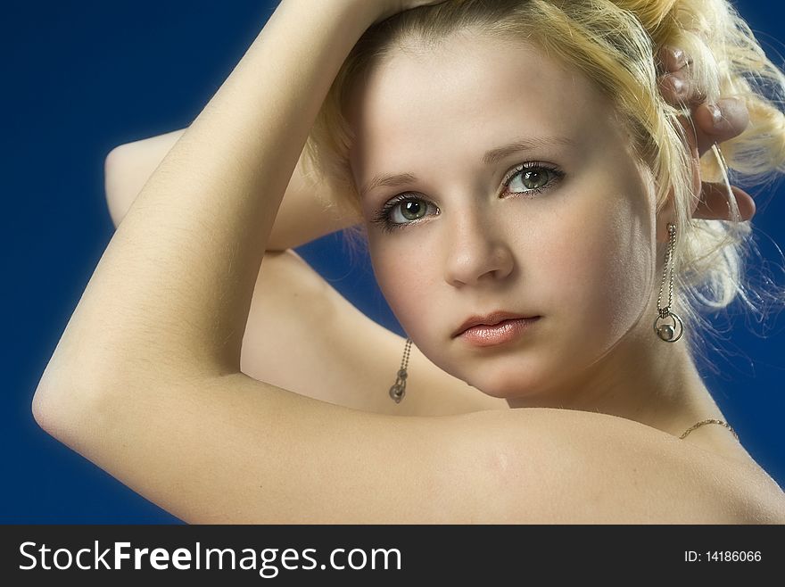 Portrait of beautiful girl on a dark blue background