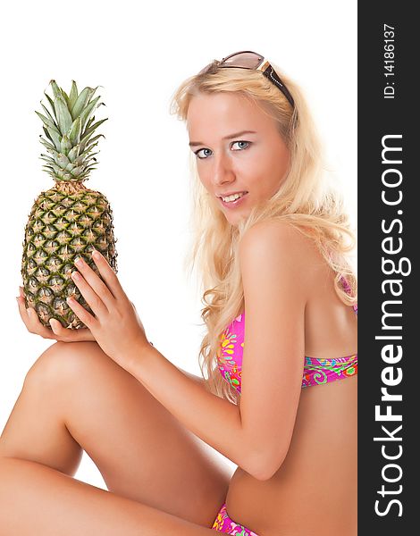 Beautiful girl in bikini with pineapple