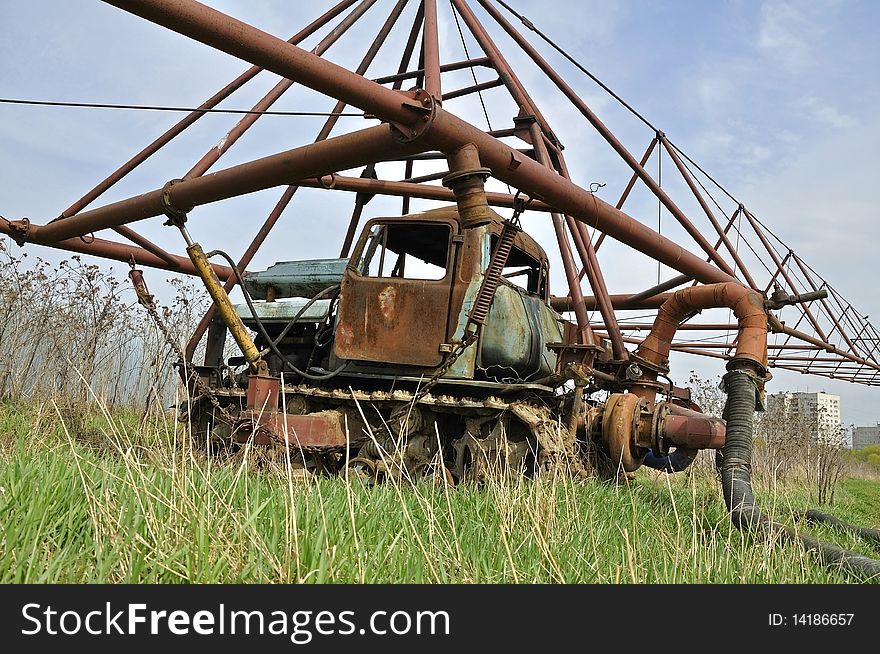The big rusty sprinkling tractor