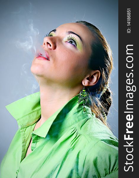 Portrait of young beautiful woman smoking.