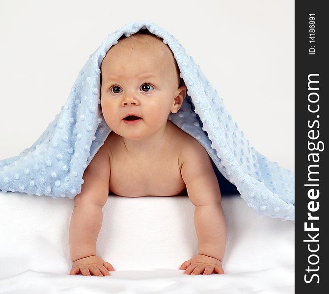 Baby under a blue towel. Baby under a blue towel