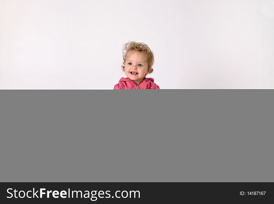 A little girl sitting between colorful baloons with a birthday cake. A little girl sitting between colorful baloons with a birthday cake