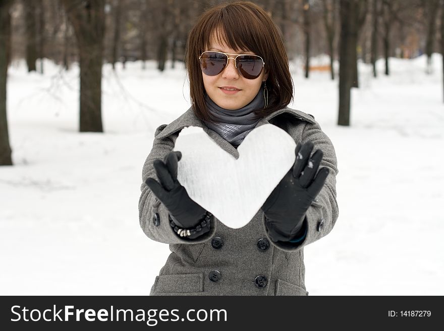 Girl holding an ice heart outdoor
