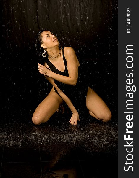 Full length portrait of a sexy woman in water studio