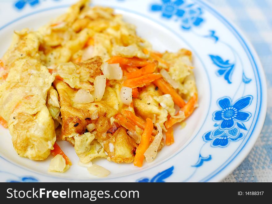 Asian fried or scrambled egg cooked with vegetables. Suitable for concepts like food and beverage, healthy living and lifestyle, and diet and nutrition.