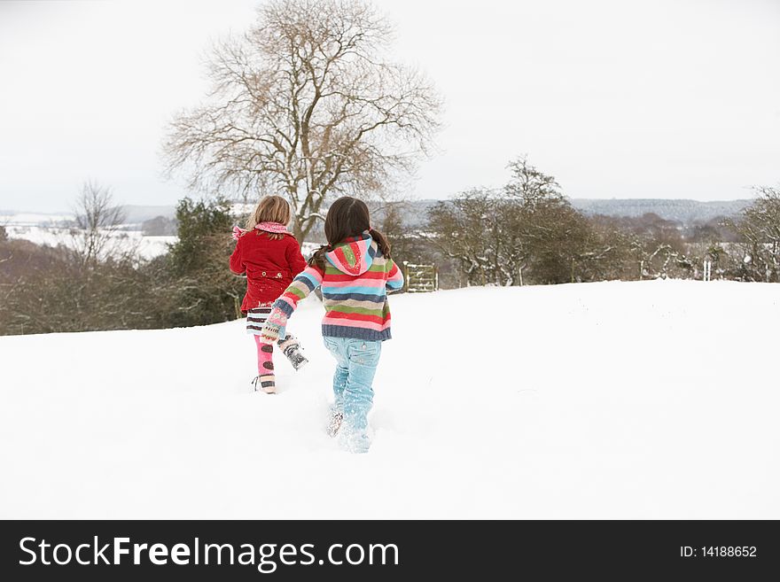 Group Of Children Having Fun In Snowy Countryside