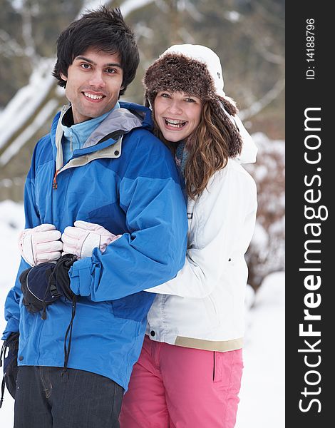 Romantic Teenage Couple In Snow wearing winter clothes