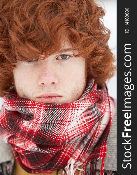 Teenage Boy Wearing Winter Clothes In Snowy Landscape