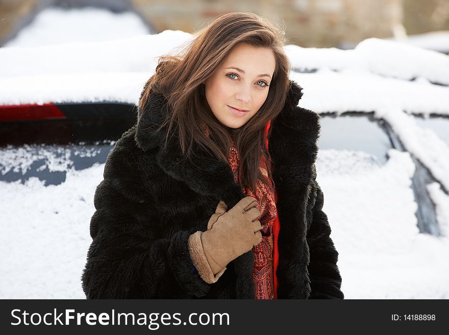 Close Up Of Teenage Girl Wearing Fur Coat In Snowy Landscape