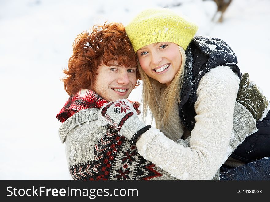 Teenage Couple Having Fun In Snow