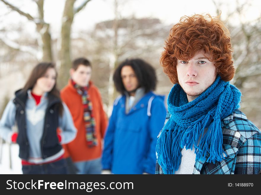 Group Of Teenage Friends Having Fun In Snowy Landscape Wearing Ski Clothing