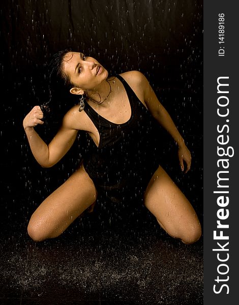 Full length portrait of a sexy woman in water studio