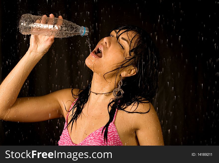 woman drinking water in studio. woman drinking water in studio