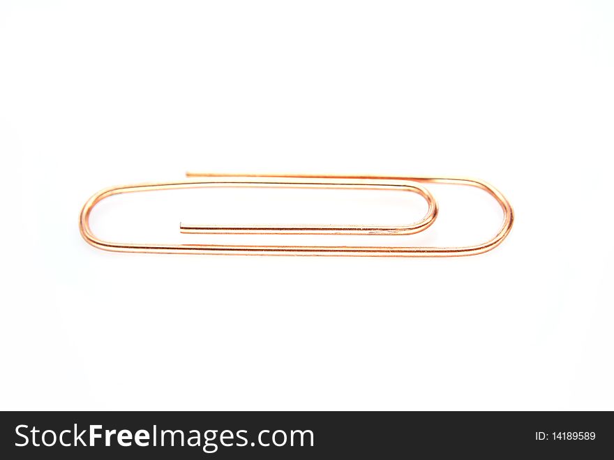 Coper metal paper clip macro isolated on white background
