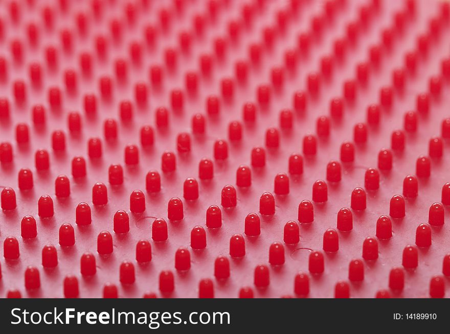 Red plastic pattern background macro shot (blurred background)