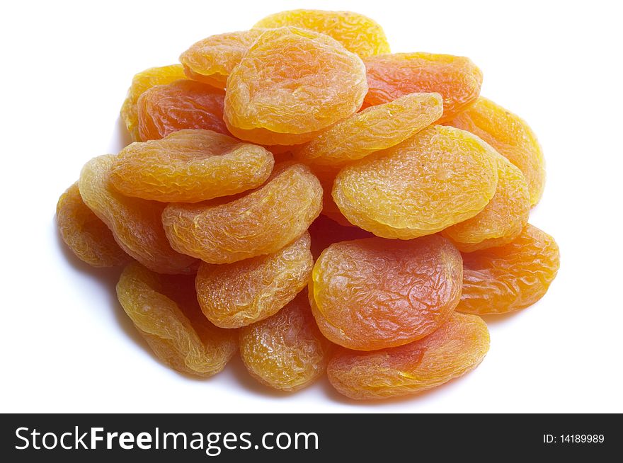 Dried apricots heap isolated over white background macro shot