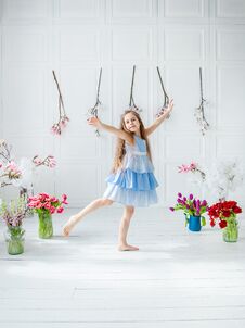 Portrait Of A Beautiful Blue-eyed Girl, A Little Girl Among Spring Flowers In A Bright Room Stock Images