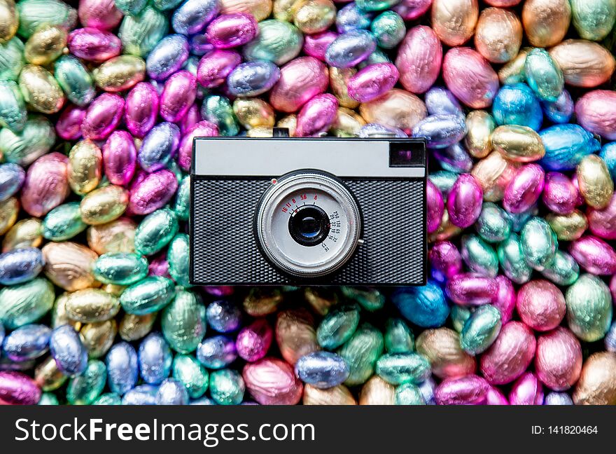 Color Chocolate Easter eggs and vintage photo camera