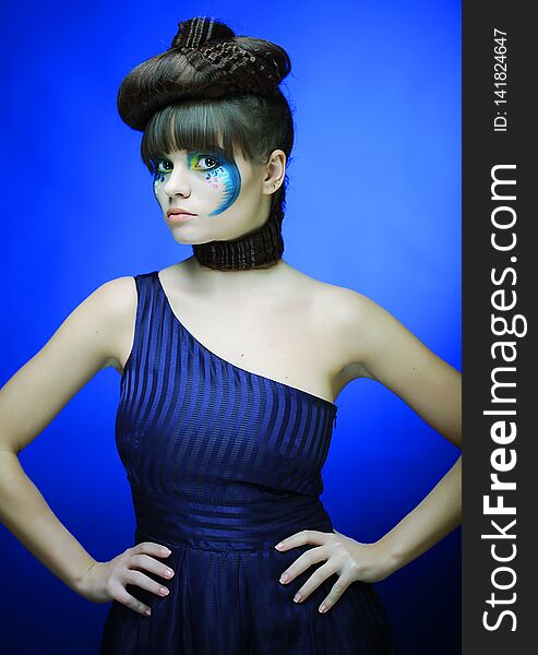 Brunette with creative make up in blue dress