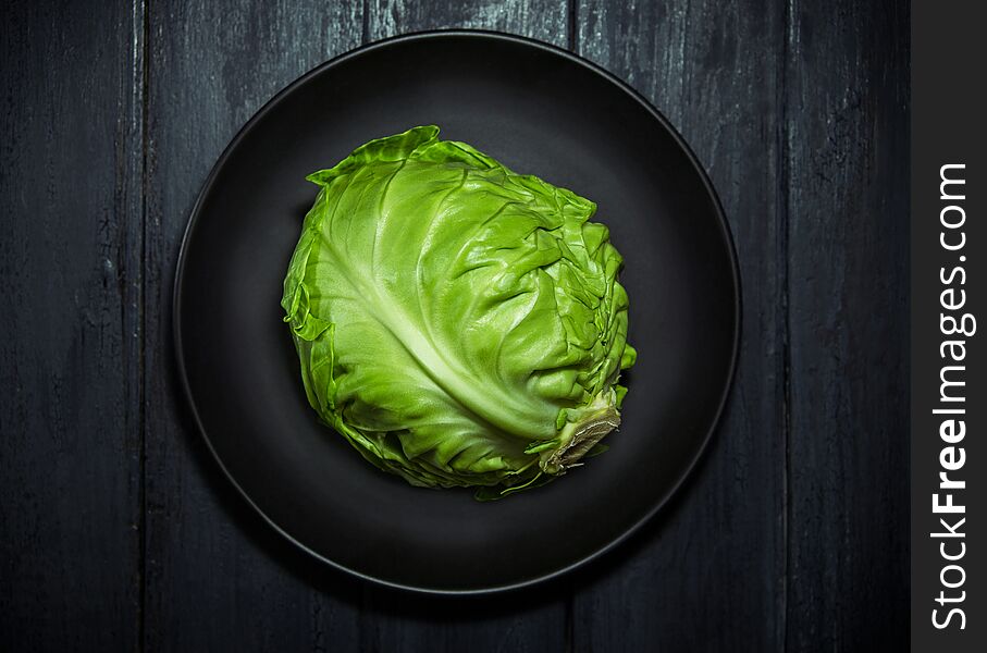 Fresh green cabbage on wooden background