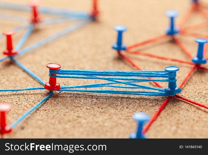 Business team. Connect between business partners people. Contract and negotiation. Blue and red knitted office pins and strong ties between businessmen.