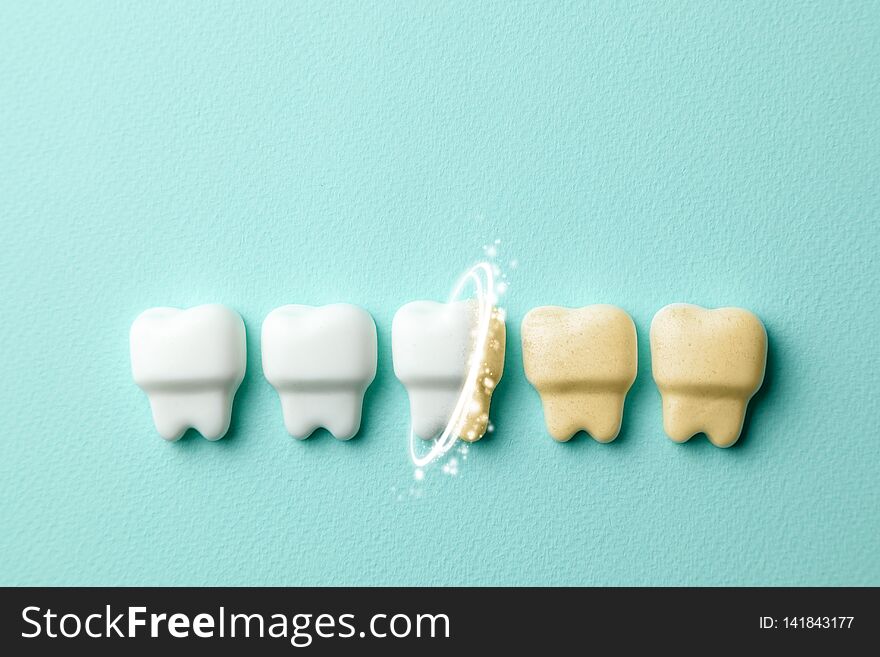 Teeth Whitening. Healthy White Teeth And Yellow From Cigarettes And Coffee On Green Mint Background.