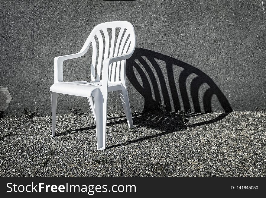 White chair with a powerful shade. White chair with a powerful shade