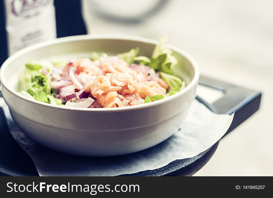 Smoked salmon salad with red onion in restaurant in Syracuse, Sicily, Italy.