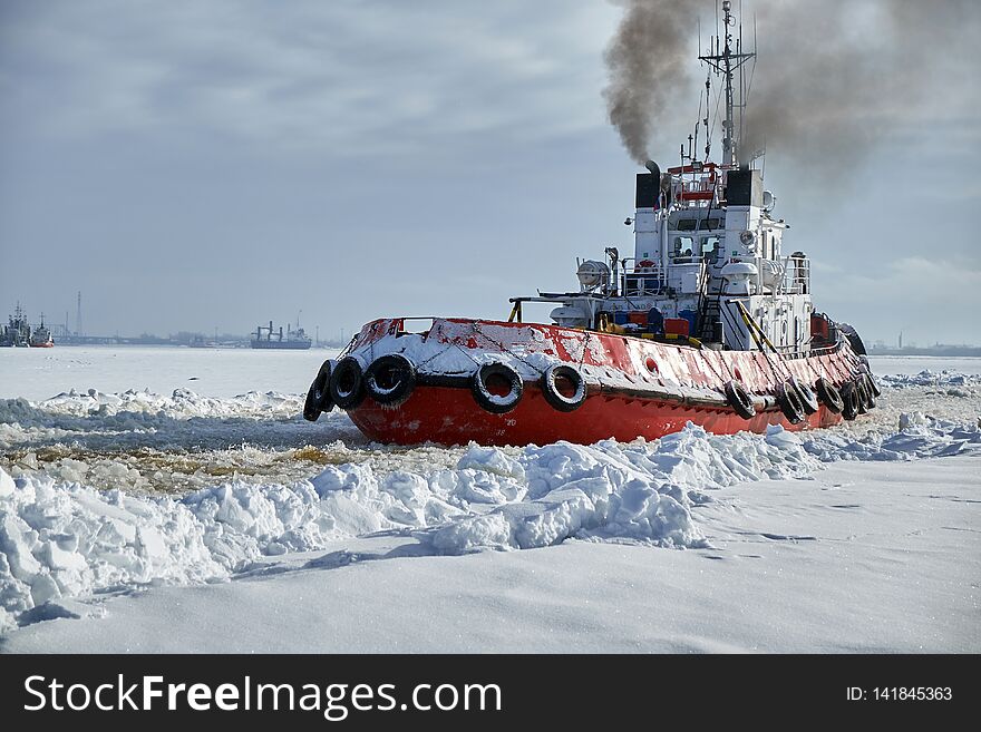 River tug in winter on the Northern Dvina River. River tug in winter on the Northern Dvina River