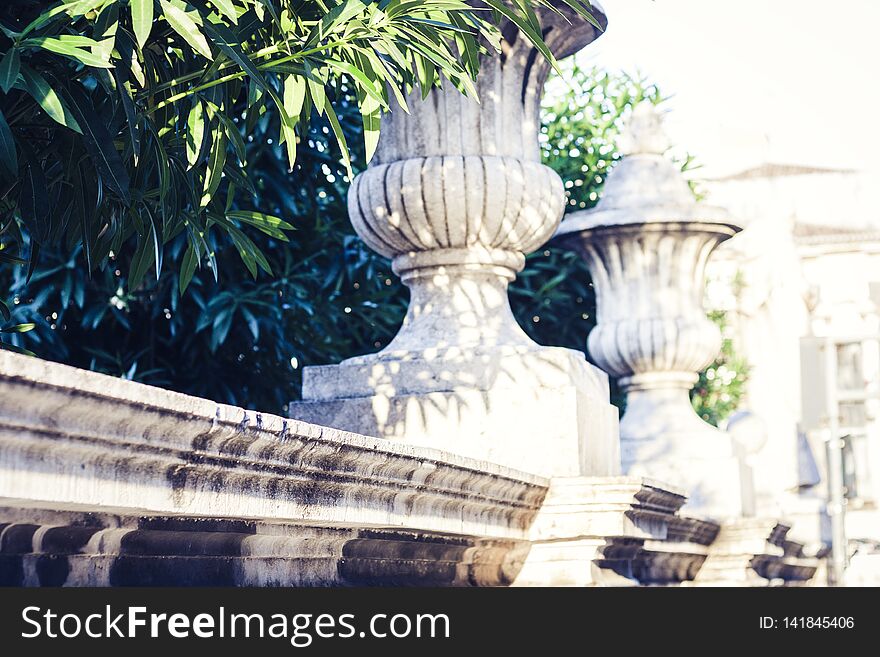 Old baroque fence with stone plant pots in Catania, Sicily, Italy.