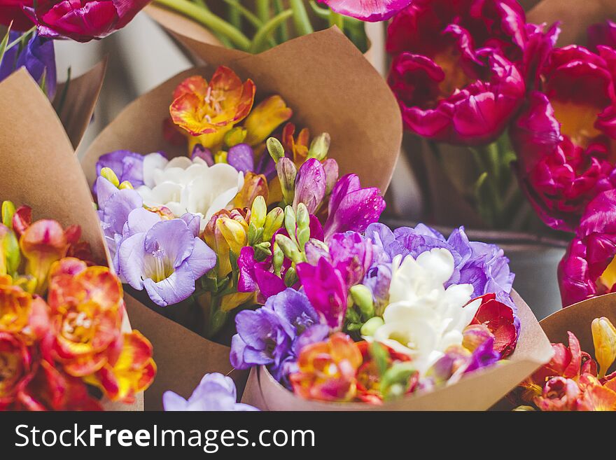 Bouquet of colorful fresh freesia in a craft paper background