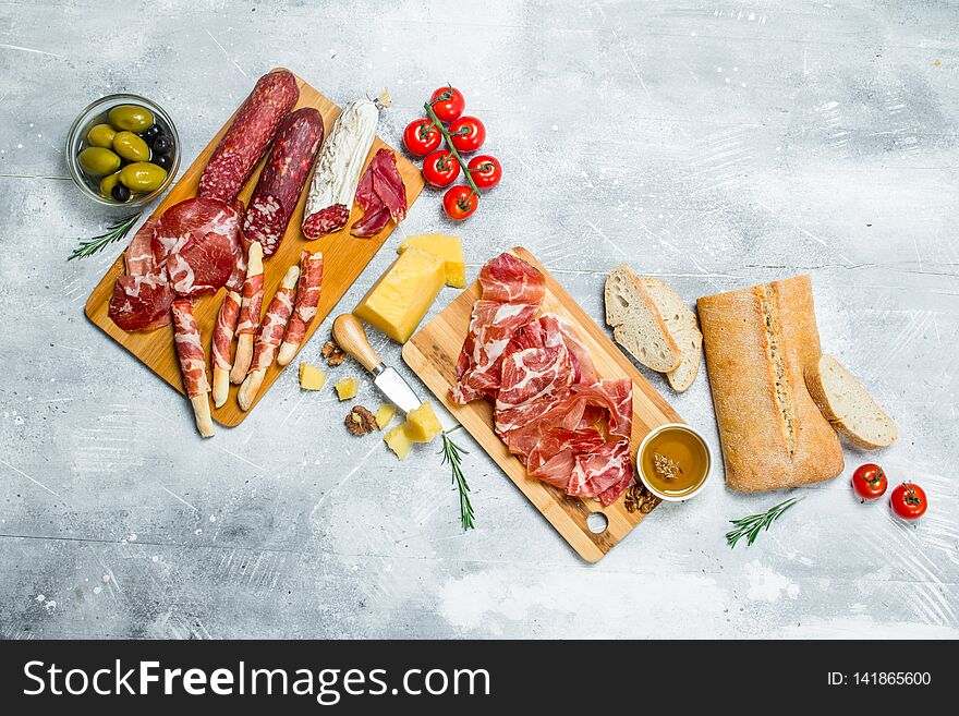 Antipasto background. Variety of Italian snacks. On a rustic background