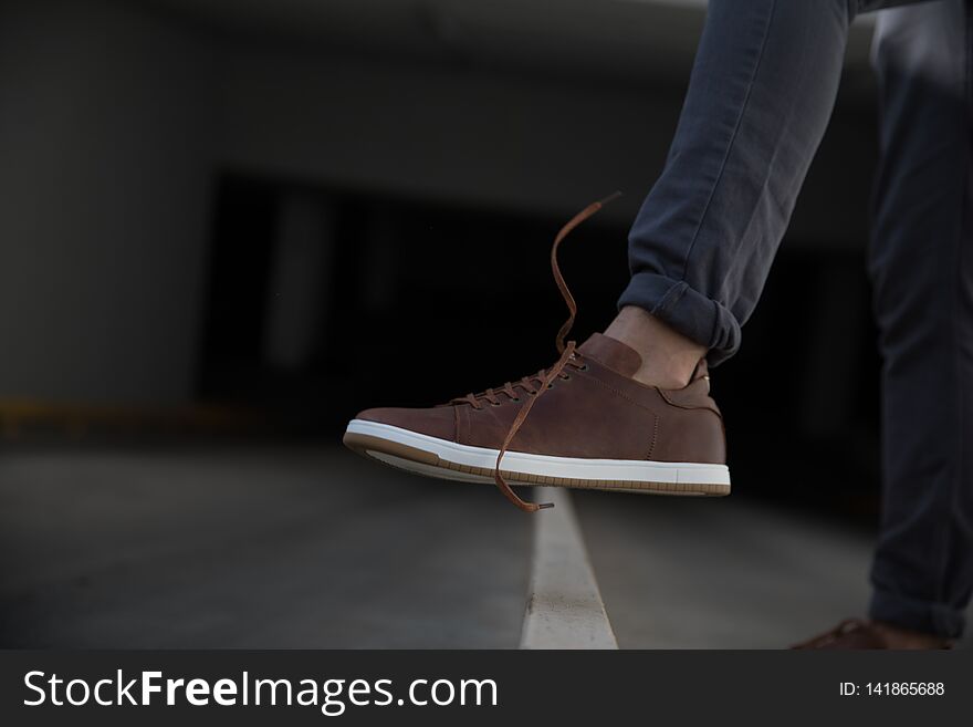 The man wears sneakers isolated on white background. The man wears sneakers isolated on white background