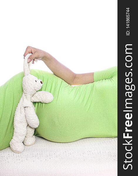 A Happy pregnant girl lies on white background