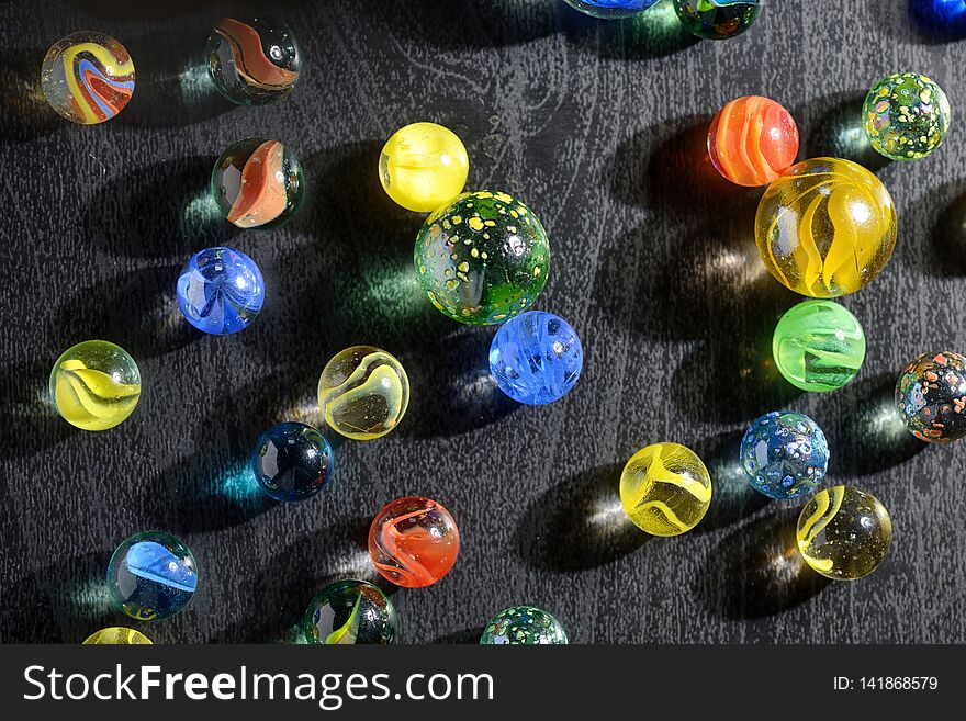 Glass marble balls and shadows on table