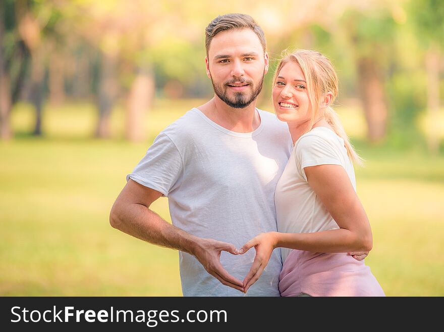 Portrait of Young couple enjoying in the park at sunset. Concept romantic and love. Warm tone.