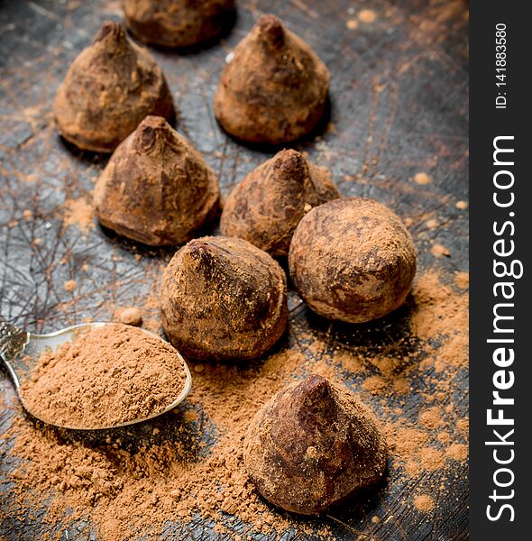 Chocolate candy truffles. On a wooden background