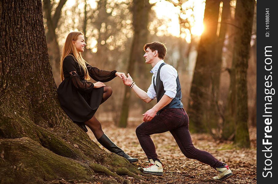 Romantic date of loving young couple in classic dress in fairytale forest park