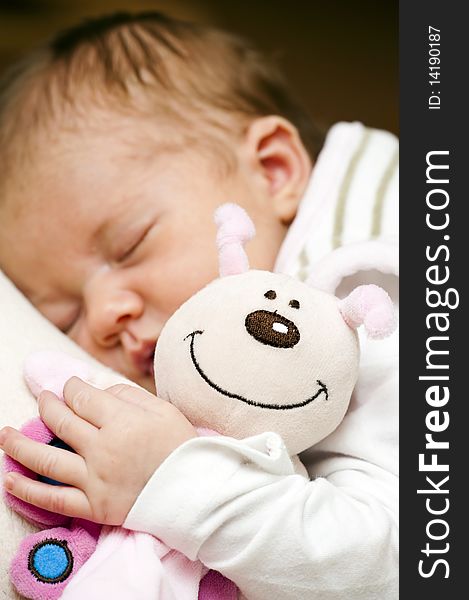 Close-up of a stuffed animal and a sleeping baby. Close-up of a stuffed animal and a sleeping baby
