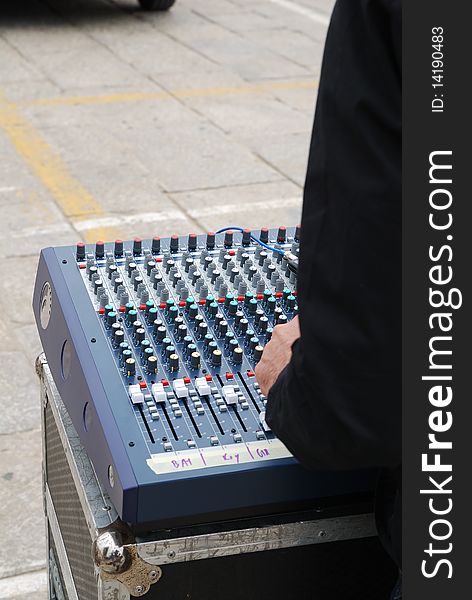 Audio mixer console being operated at outdoor show