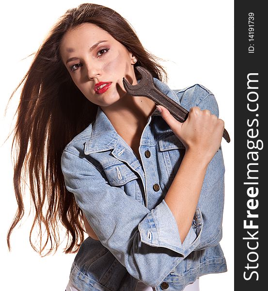 Young beautiful woman in jeans jacket with wrench. Young beautiful woman in jeans jacket with wrench