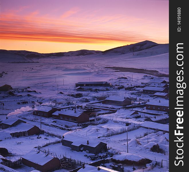 A village afetr snow in the sunrise