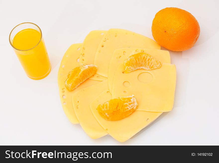 Yellow cheese  on the  plate.Orange juice  in a glass. Yellow cheese  on the  plate.Orange juice  in a glass.