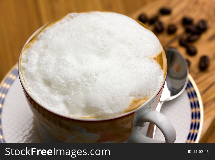 A Cup of Cappuccino on the wooden Background