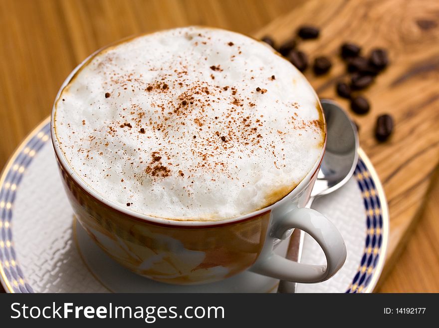 Cup Of Cappuccino On The Wooden Background