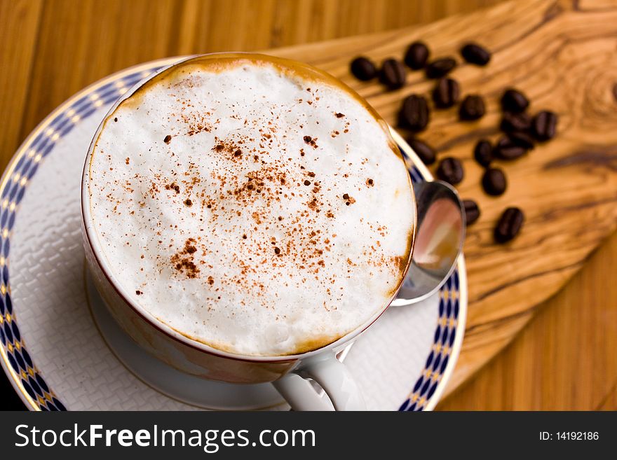Cup of Cappuccino on the wooden Background .