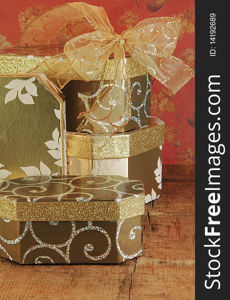 Gift boxes stacked with gold ribbon..