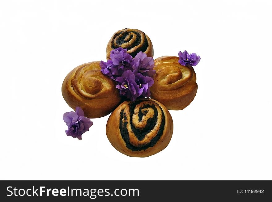 Two buns with poppy seeds and two buns with cheese, decorated with flowers of violet. Photography. Two buns with poppy seeds and two buns with cheese, decorated with flowers of violet. Photography