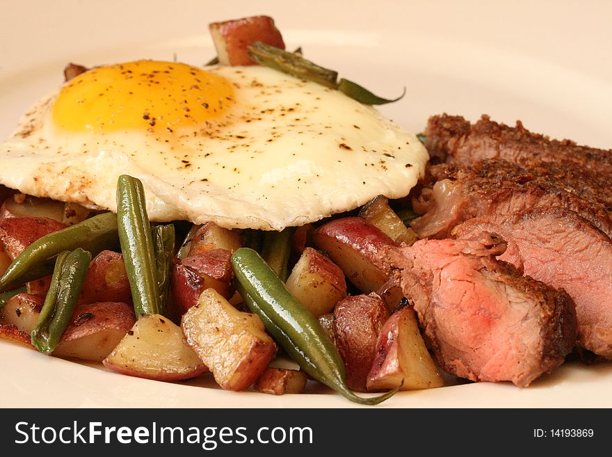Potato and green bean hash with sirloin steak and egg