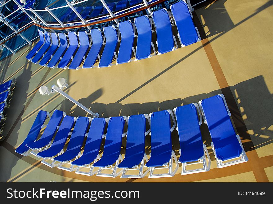 These are 2 rows of loungers on board a cruise ship, which forms 2 beautiful curves. shot from a tilted angle. These are 2 rows of loungers on board a cruise ship, which forms 2 beautiful curves. shot from a tilted angle